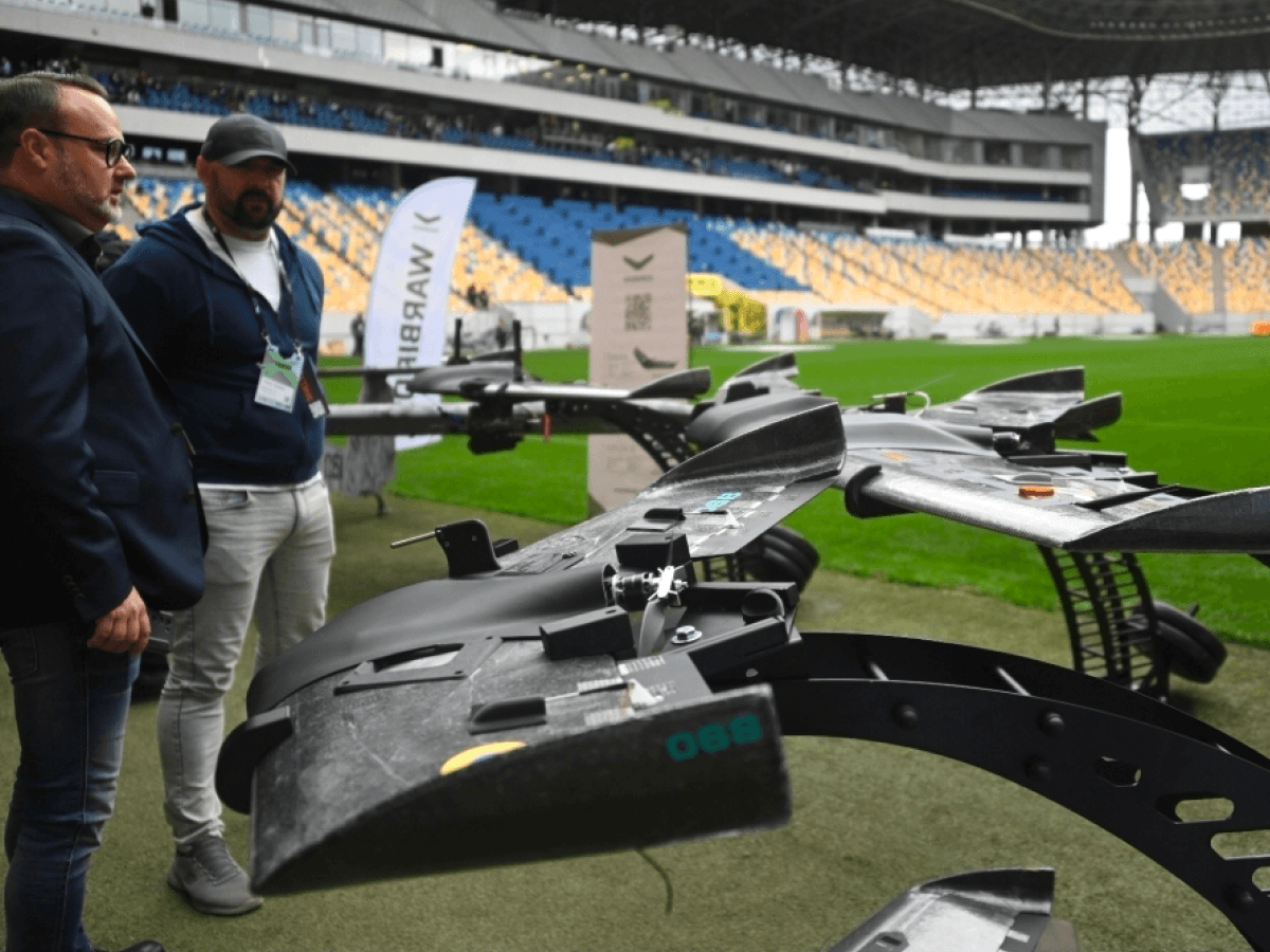 Team members with a large drone at a stadium
